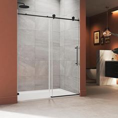 a bathroom with a walk in shower next to a white sink and brown tiled walls