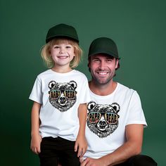 Papa Bear Shirt, Vintage Papa Bear Set, Papa Bear Baby Bear Shirt, Fathers Day Shirt, Bear Family Shirts, New Dad Gift, Baby Shower Gift, Dad Shirt The Standard T-Shirt, personalized to suit your individual style, serves as the perfect medium for self-expression. Made from 100% preshrunk cotton, this timeless short-sleeve tee not only ensures comfort but also offers ample opportunities for print-on-demand customization. Whether you seek to showcase your creativity, promote your brand, or commemo Cute White T-shirt With Bear Design, White Bear Design Short Sleeve Tops, White Short Sleeve Top With Bear Design, Playful White T-shirt For Father's Day, Papa Bear Shirt, New Dad Gift, Embroidery Download, Bear Family, Papa Bear