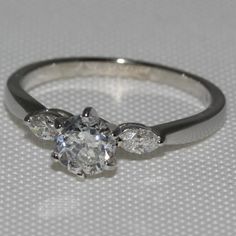 an engagement ring with three diamonds on it