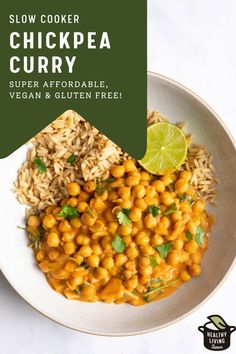 a white plate topped with rice and chickpea curry next to a lime wedge