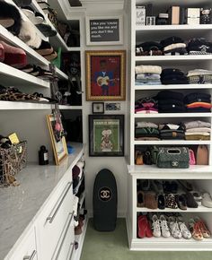 a walk in closet filled with lots of shoes and handbags on top of shelves