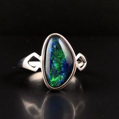 "Natural Australian black Opal triplet Sterling Silver Ring, one-off piece of natural opal set in sterling silver in a modern design.  💎 Main Gemstone: Natural Australian Black Opal 💎 Material: Solid British Sterling Silver with rhodium plating.  Please note: All my Australian black Opals are one-off pieces so some rings will need to be resized to your size once the order is placed, please allow 4-5 working days for me to change the size for you.  To protect the natural Opal please avoid getti Silver Opal Ring With Polished Finish, Formal Sterling Silver Opal Cabochon Ring, Sterling Silver Opal Cabochon Ring, Black Opal Cabochon Ring As Gift, Oval Black Opal Jewelry, Black Opal Fine Jewelry, Oval Multi-stone Opal Ring In Sterling Silver, Black Fire Opal, Natural Opal Ring