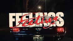 the back end of a car that is parked in front of a street sign with lettering on it