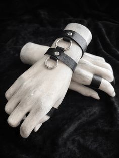 "Dual band linked black cuff bracelet with silver accents. ~ jet black arm bands made from faux vegan leather ~ save $ by stocking up! layer your pieces on one arm or both ~ upper band: 5/8\" wide - lower band: 1/2\" wide | middle o-ring: 1\" wide - drop o-ring: 7/8\" wide ~ adjustable slider with hook closure ~ bands are secured with silver rivets, and have black nylon coated metal hardware ~ made-to-order: please measure your wrist circumference, and choose from the options in the drop down me Punk Wrist Cuffs, Goth Armor, Arm Band Design, Goth Bracelets, Armor Jewelry, Leather Rings, Black Cuff Bracelet, Bracelet Cuffs, Leather Wrist Cuff