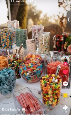 a table topped with lots of candy and candies on top of it's sides