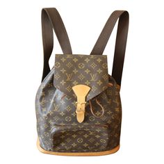 This beautiful Louis Vuitton backpack features monogram canvas and gently tanned leather pieces. It has got golden color hardware and 2 comfortable adjustable shoulder straps in cotton and leather and one leather top handle.It features a zip pocket on its front. Designed by Nicolas Ghesquière, this backpack in Monogram coated canvas is an ode to travel and adventure. This Vuitton backpack has a front zipped pocket and secure drawstring . Please note that in this front pocket, there is a stain of ink as you can see on photos. The natural cowhide-leather trim perfectly complements the Monogram pattern. Its interior is in brown color canvas.It has got one large flat pocket inside as well as its embossed serial number. It could be worn by women and men. It is as chic as convenient, perfect for Louis Vuitton Backpack, Travel And Adventure, Nicolas Ghesquiere, Leather Pieces, Golden Color, Backpack Purse, Leather Top, Monogram Canvas, Fashion Handbags