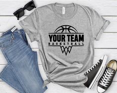 a t - shirt that says your team basketball on the front, next to jeans and sneakers