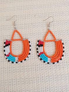 Circle Earrings | Custom Earrings | Hoop Earrings | Dainty Earrings | Beaded Earrings | Moms Gift | Gift Ideas | Unique Gift These eye catching  earrings are superbly crafted and can be worn with any outfit.The earrings are very light to wear.Main Color - multi color.The earrings measure 3 inches from top of the hook.**Buy multiple items and pay shipping for 1 item only.The rest ships free.Feel free to send me a convo or e-mail for any clarification or wholesale pieces.Thank you for visiting... Traditional Handmade Hoop Beaded Earrings, Traditional Small Hoop Handmade Beaded Earrings, Traditional Small Hoop Beaded Earrings, Handmade White Drop Wrap Earrings, Handmade White Drop Earrings, Handmade White Wrap Drop Earrings, Artisan Orange Beaded Earrings, Artisan Beaded Hoop Earrings, Orange Beaded Hoop Earrings As A Gift