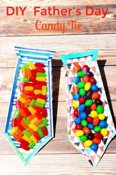 two paper bags filled with gummy bears on top of a wooden table next to each other