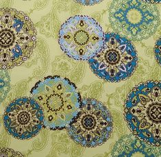 a green and blue floral pattern on fabric