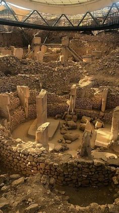 an ancient building in the middle of a desert area with stone walls and steps leading up to it