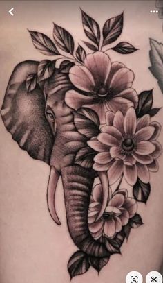 an elephant with flowers on it's back is seen in this tattoo photo taken by the