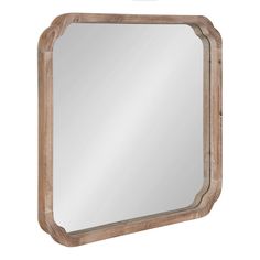 a wooden mirror hanging on the wall