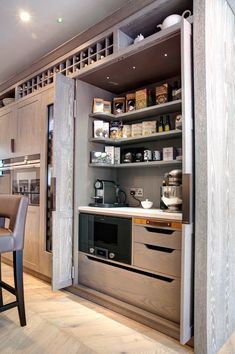 a kitchen with an oven, counter top and shelves in the corner that are open