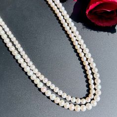 Featuring a timeless classic 2 line pearl string necklace. Must have for every women, this aesthetic piece pairs well with Indian as well as Western outfits. Crafted with love, this 2 line pearl string necklace will complete any look while adding a touch of elegance and sophistication. An essential addition to any wardrobe. Length 42 CM Weight of pearls - 62.60 GMs Elegant Double Strand Pearl Necklace With Pendant, Elegant Double Strand Pearl Chain Necklace, Elegant Double Strand Pearl Necklace With Charm, Double Strand Pearl Necklace For Formal Occasions, Elegant Double Strand Akoya Pearl Necklace, Formal Double Strand Pearl Necklace With Pendant, Elegant Double Strand Pearl Embellished Necklace, Luxury Double Strand Pearl Necklace, Formal Double Strand Pearl Necklace