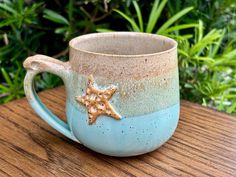 a blue and white coffee cup with a starfish on it