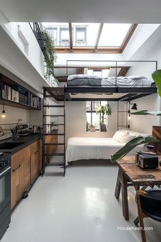 a loft bed in the middle of a kitchen with an open floor plan and skylights