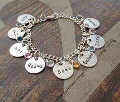 "Personalized Charm Bracelet Grandma Bracelet Grandchild Bracelet Handstamped Jewelry Mom Charm Bracelet Grandma Gift Mothers Day Gift Handstamped charm bracelet with names of loved ones. This bracelet makes a loving gift to any member of your family or friends. * 3/4\" Brushed Aluminum disc stamped with \"Names of Choice\" * Swarovski crystal birthstones of choice * Stainless Steel Chain. Samples shown are stamped in 3mm Angelina at check-out, please leave information **names **birthstone or bi Silver Name Charm Bracelet For Birthday Gift, Silver Charm Bracelet With Name For Birthday Gift, Personalized Bracelets As Mother's Day Gifts, Nickel-free Charm Bracelet For Birthday Gift, Nickel-free Charm Bracelet For Birthday, Nickel-free Round Charm Bracelet As Birthday Gift, Nickel-free Round Charm Bracelet For Birthday Gift, Nickel Free Round Charm Bracelet For Birthday, Nickel-free Round Charm Bracelet For Birthday