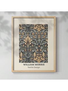 the william and mary wall hanging in front of a white wall with an ornate pattern on it