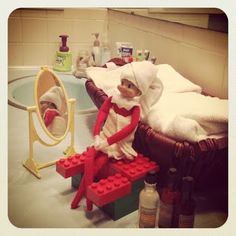 an elf is sitting on a lego bench in front of a bathroom mirror and sink