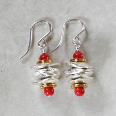 "Silver Chunk Earrings with Coral Pearl - Pearl and Silver Earrings - Red Earrings - Unusual Earrings - Silver & Gold Stacked like little pancakes, these whimsical pearl and silver earrings feature chunky beads of plated fine silver with gold plated washers and luminous, Swarovski coral pearls. The earring wires are sterling silver. A charming mixture of textures, shapes, and metals! Also available with Swarovski white pearls, green pearls, turquoise pearls, lapis pearls, and jade pearls. Th Nickel Free Red Earrings For Anniversary, Nickel-free Red Earrings For Anniversary, Spiral Shaped Red Jewelry For Gifts, Red Spiral Jewelry For Gifts, Red Spiral Jewelry As Gift, Red Metal Earrings For Anniversary, Single Red Sterling Silver Earring, Unique Red Earrings For Gift, Unique Red Pierced Earrings