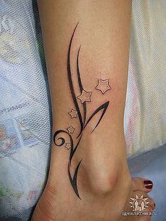 a woman's foot with a tattoo design on the side of her left leg