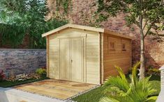 a small wooden shed sitting next to a tree and shrubbery on the side of a brick building