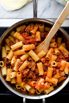 a skillet filled with pasta and meat sauce