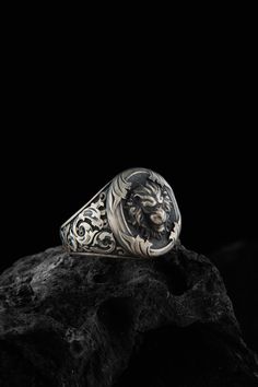 This silver lion head figure ring is a bold and eye  catching piece of jewelry that is perfect for anyone with a love of nature or a fascination with these majestic creatures. The ring is made of sterling silver and features a detailed design of a lion head, with its powerful and regal features expertly captured in the design. The intricate detailing on the ring makes it a standout piece that is sure to become a favorite in your collection. Wear it alone as a statement piece or pair it with othe Leo Ring, Angry Lion, Lion Jewelry, Majestic Creatures, Lion Ring, Animal Ring, Handmade Wooden Boxes, Head Ring, Ring Mens