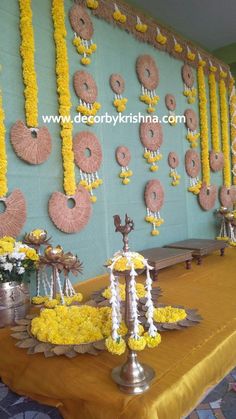 the table is covered with yellow flowers and donuts hanging from it's sides