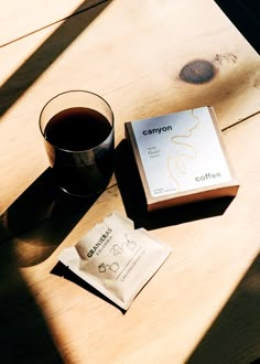 a cup of coffee sitting next to a box of candy