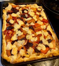 an uncooked pizza sitting on top of a pan covered in cheese and toppings