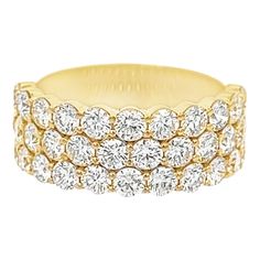 a yellow gold ring with three rows of diamonds