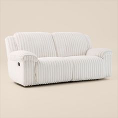 a white corded couch sitting on top of a floor