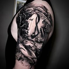 a man with a tattoo on his arm that is covered in black and white artwork