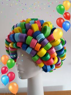 a white mannequin head with lots of colorful hair and balloons floating in the air