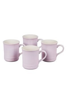 four purple coffee mugs sitting next to each other