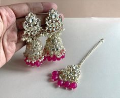 Magenta Pink Gold and Pearl Jhumkas with matching tikka ------------------------------------------------------------------------------ ♡ SPECIAL PRICING ♡   Buy 2 or more items and get free delivery anywhere in Canada. Free US delivery for orders over $35 USD ♡ WEBSITE ♡  Shop directly on our website for more deals  www.TheJewelBlitz.com  ------------------------------------------------------------------------------ ♡ SHIPPING ♡   All of our orders come with tracking and are usually shipped next Pink Festive Tikka, Bollywood Style Pink Kundan Tikka, Traditional Pink Tikka For Parties, Festive Pink Kundan Tikka, Pink Kundan Tikka For Diwali, Pink Stone Work Tikka For Festive Occasions, Pink Tikka With Latkans For Festivals, Traditional Hand Set Pink Earrings, Traditional Pink Hand Set Earrings