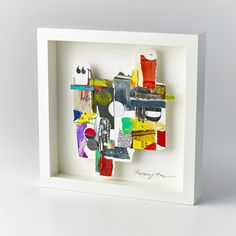 an abstract painting in a white box frame