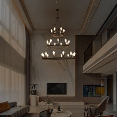 a living room with couches, chairs and a chandelier hanging from the ceiling