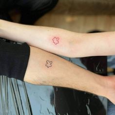 two people with matching tattoos on their arms