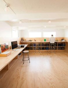 a man is standing in the middle of a room with many desks and computers