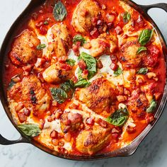 a skillet filled with chicken and tomato sauce