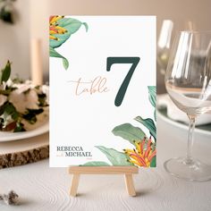 Print your wedding table numbers for your wedding reception! This table number template features a tropical leaf background with stunning orange tropical flowers and editable fields for the table number, bride and groom's names, and wedding date. Simply duplicate pages and modify your text to print as many table numbers as needed for your event. Access the online editing version by placing an order on Etsy. Upon purchase, you'll receive an email from Jet Template containing a link to access your Tropical Table Numbers, Tropical Leaf Background, Orange Tropical Flowers, Tropical Wedding Table, Wedding Table Numbers Printable, Numbers Printable, Printable Table Numbers, Number Templates, Printable Numbers