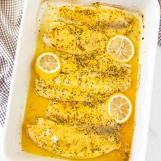 fish with lemons and seasoning in a baking dish