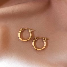 Mini chunky hoops perfect for everyday wear. Smaller than the Puv chunky hoops but bigger than the Infinity Huggies, and just as lightweight! 14k Gold Fill Diameter: 3/4" Sold as a pair Make your jewelry last! Click here for jewelry care. Need a gift box? We got you. Simple Everyday Hoop Huggie Earrings, Everyday Tarnish Resistant Rose Gold Hoop Earrings, Everyday Rose Gold Tarnish Resistant Hoop Earrings, Everyday Tarnish-resistant Rose Gold Hoop Earrings, Versatile Everyday Hoop Earrings, Simple Hoop Huggie Earrings For Everyday, Simple Everyday Hypoallergenic Hoop Earrings, Simple Hypoallergenic Hoop Earrings For Everyday, Trendy 14k Gold Everyday Earrings