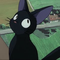 a black cat sitting on top of a window sill next to a green field