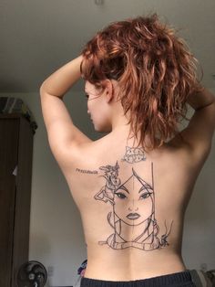 a woman with a tattoo on her back