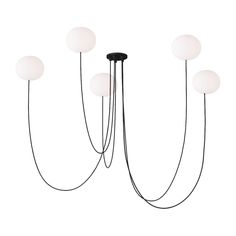 four light chandelier with five white balls hanging from the top and two black poles on