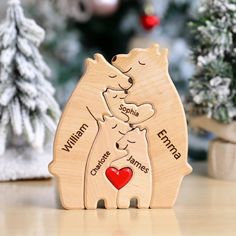 two wooden bears hugging each other with christmas trees in the background